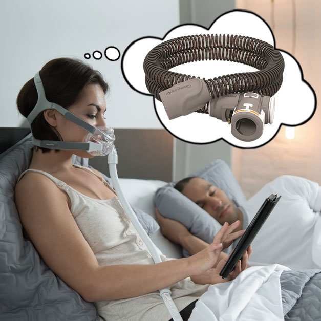 woman wearing a cpap mask, using an ipad and thinking about CPAP heated tubing accessories