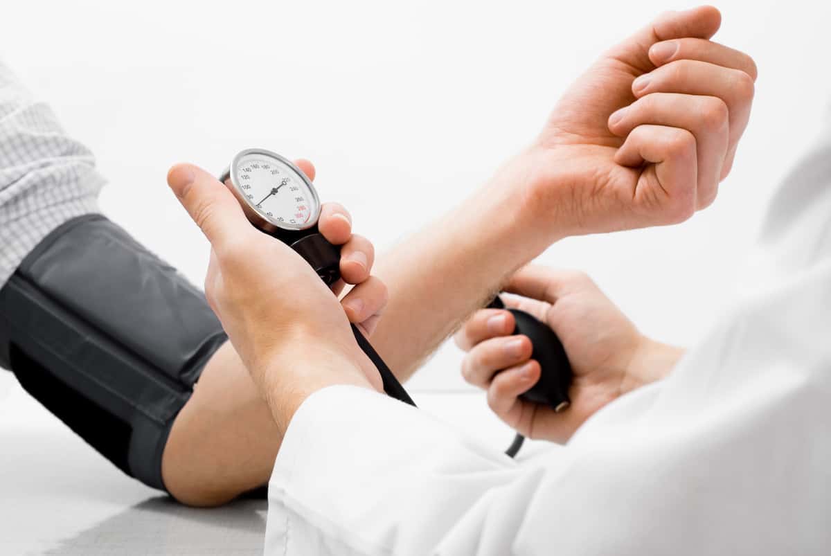 Doctor using a blood pressure device on a patient