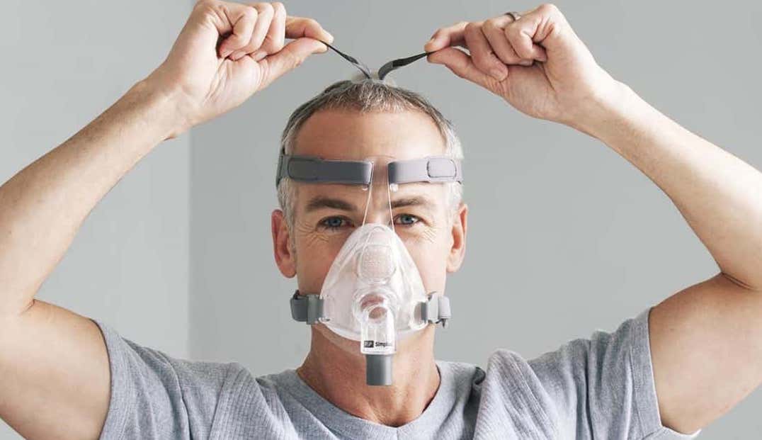 man adjusting his full face mask