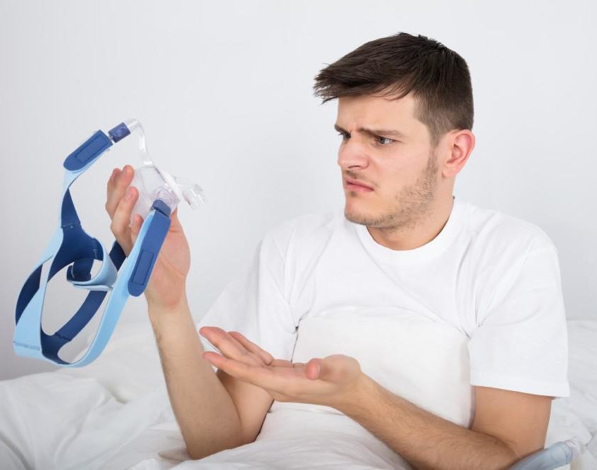 man holding cpap e1610479937791
