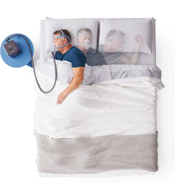 man sleeping in bed using a Sleepstyle CPAP and wearing a Vitera mask